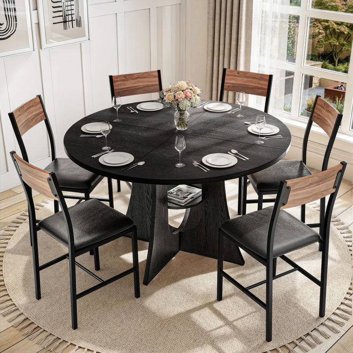 Dining room with a round black table and six chairs, set for a meal.